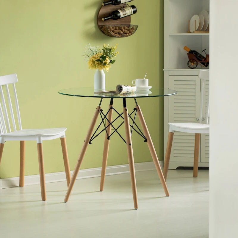 Tavolo da pranzo con piano rotondo in vetro e gambe in legno