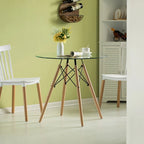 Tavolo da pranzo con piano rotondo in vetro e gambe in legno