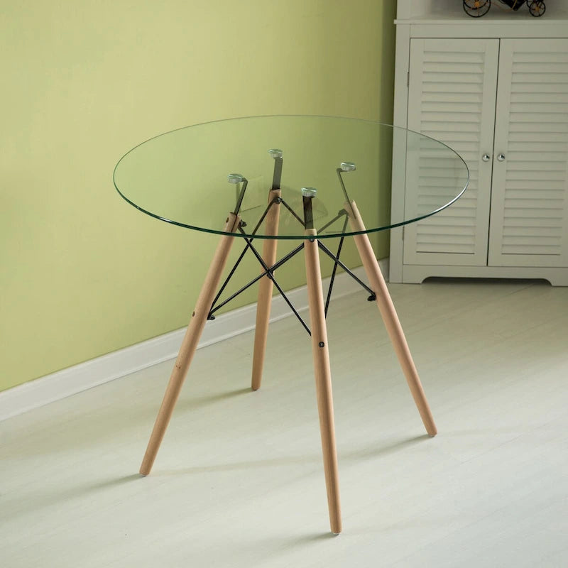 Tavolo da pranzo con piano rotondo in vetro e gambe in legno